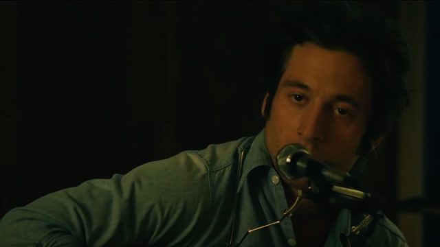 Jeremy Allen White singing into a microphone