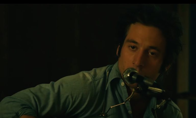 Jeremy Allen White singing into a microphone