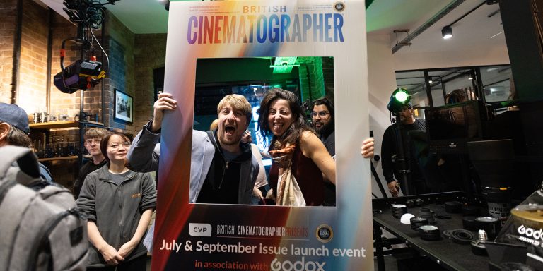 People smiling with a cardboard cutout