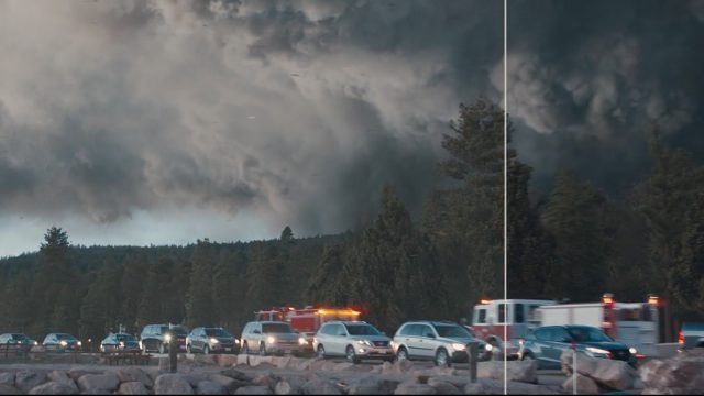 Cars in a line with smoke behind