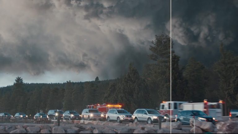 Cars in a line with smoke behind
