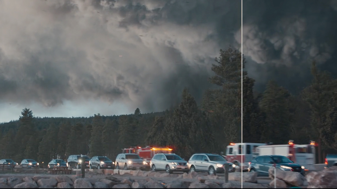 Cars in a line with smoke behind