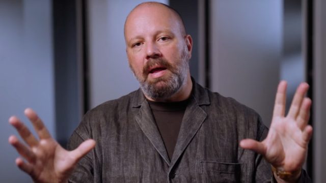 Yorgos Lanthimos with hands outstretched