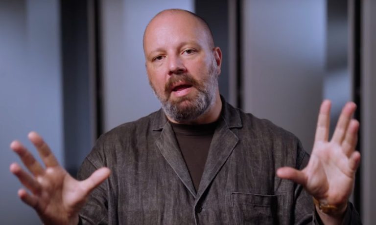 Yorgos Lanthimos with hands outstretched