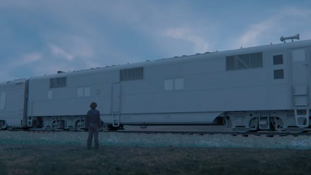 A man looking at a train