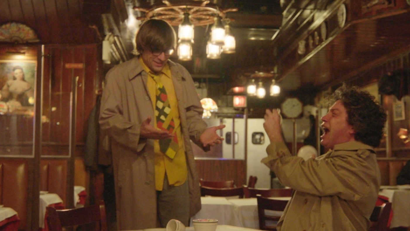 Two men laughing at each other