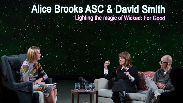 Three people sat together in a studio talking