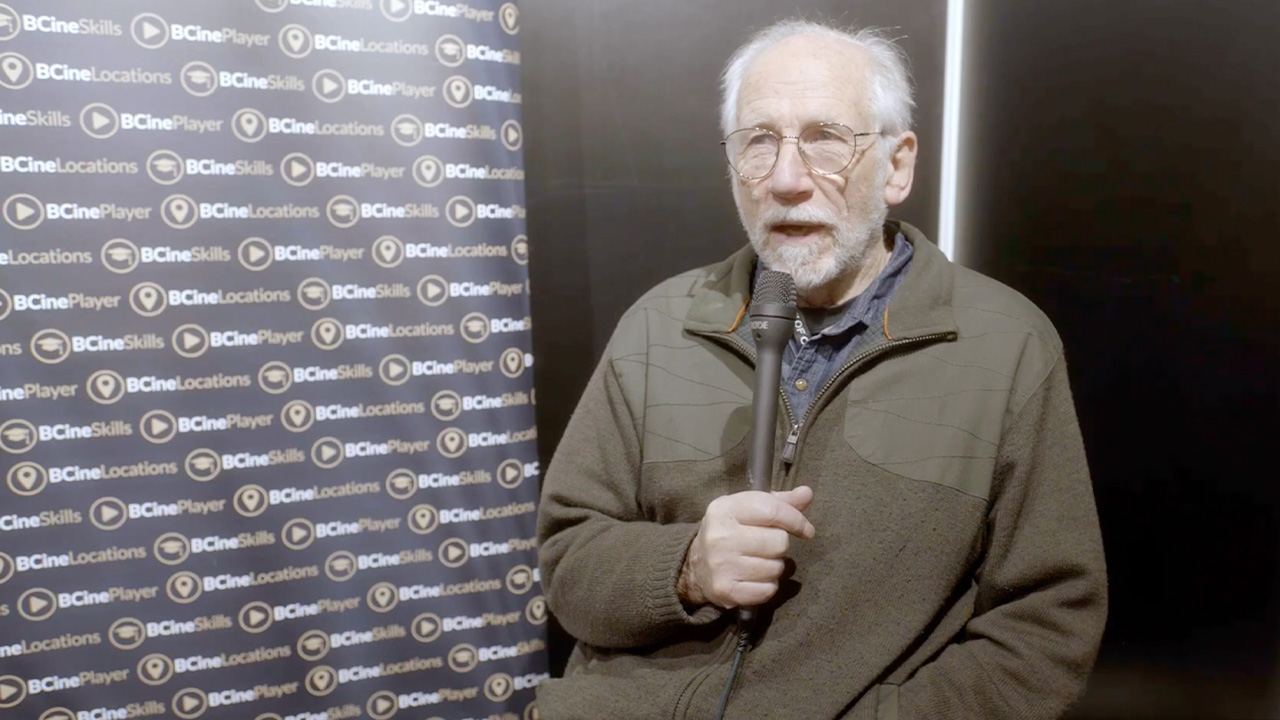 Oliver Stapleton holding a microphone
