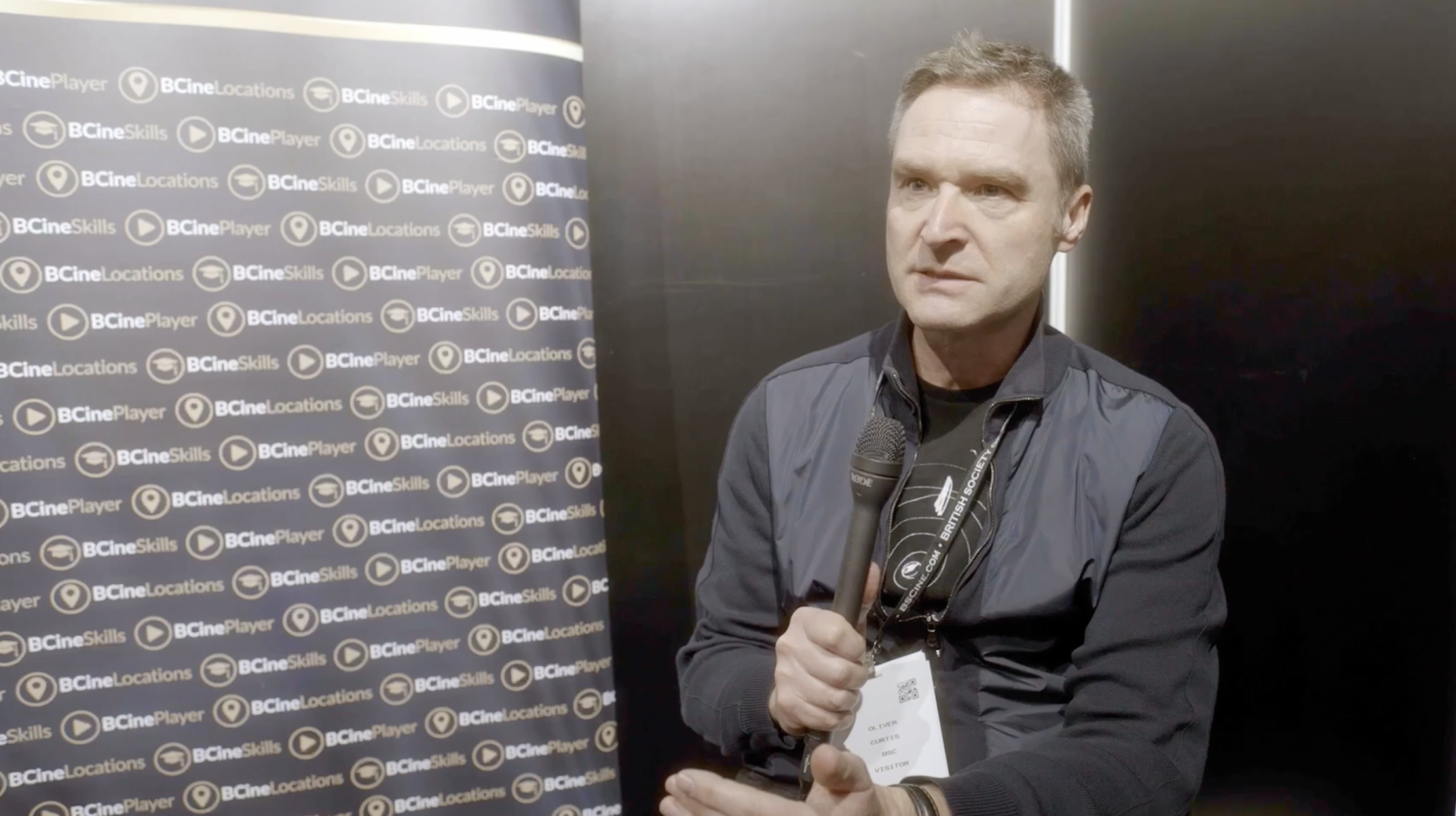 Oliver Curtis holding a microphone