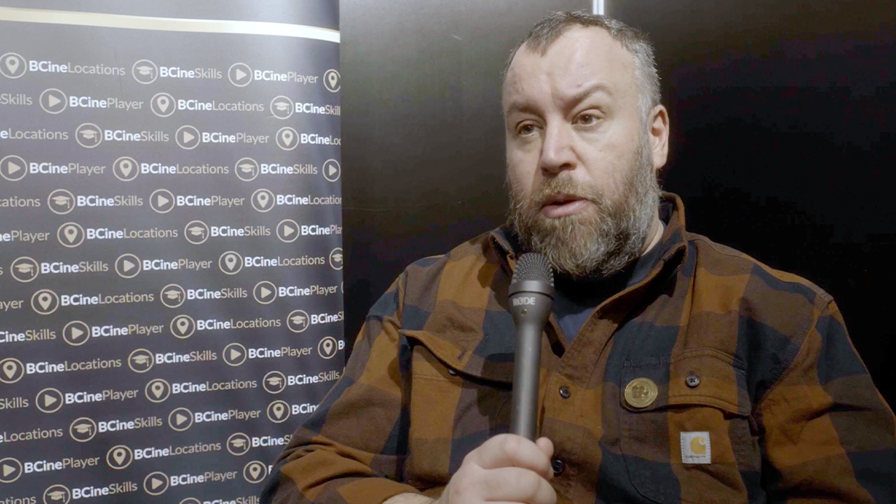 Stephen Murphy holding a microphone