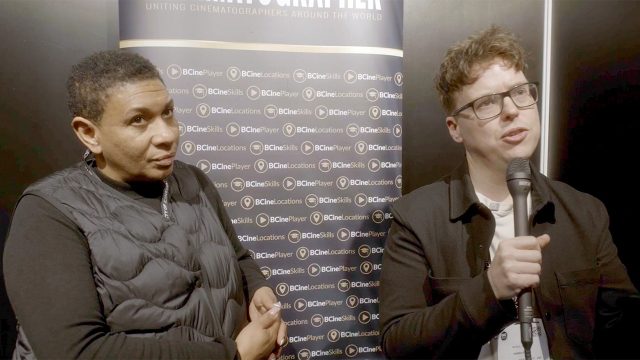 Two people sat, one with a microphone