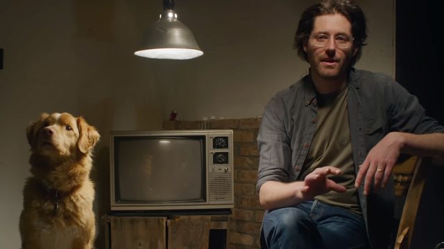 A dog and a man sat together