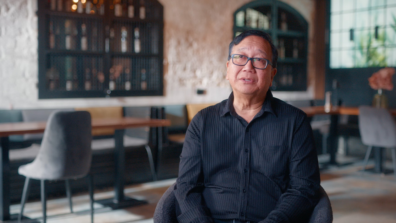 Michael Goi ASC ISC sat in a chair talking