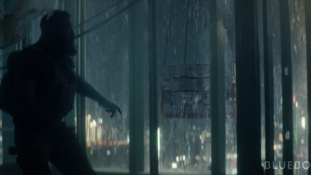 A man in fight gear against a rainy backdrop