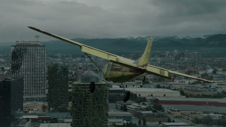 A yellow airplane flying through the air