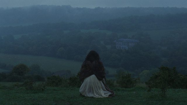 A woman sat on a hill